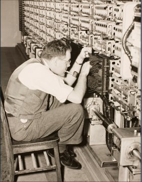 Robert Hawkins works inside the Harvard Mark I.